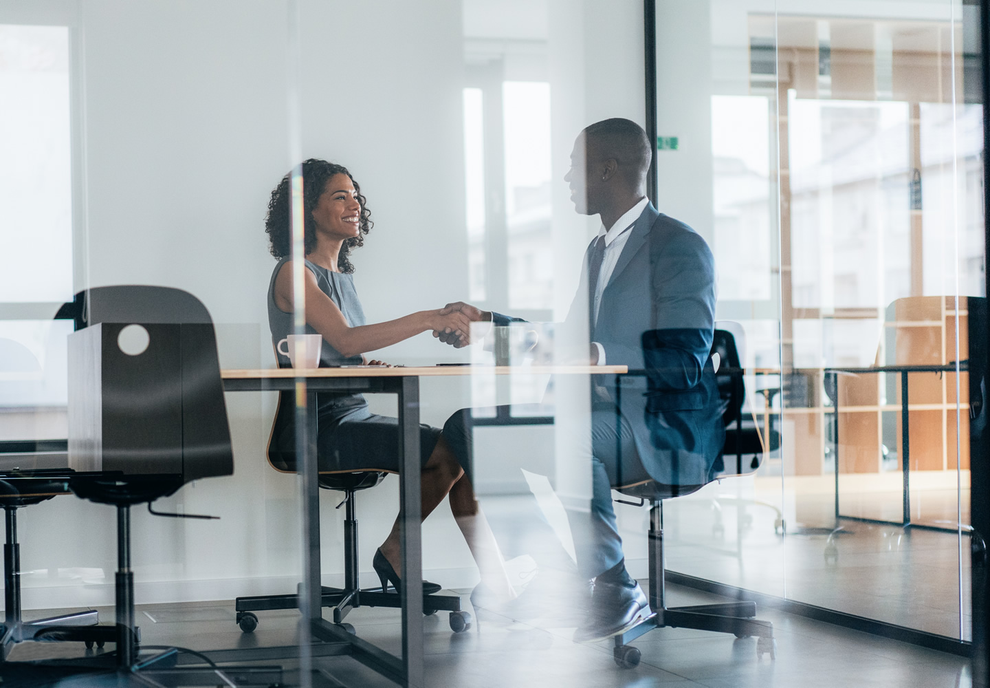 Business people shaking hands for new agreement in the office