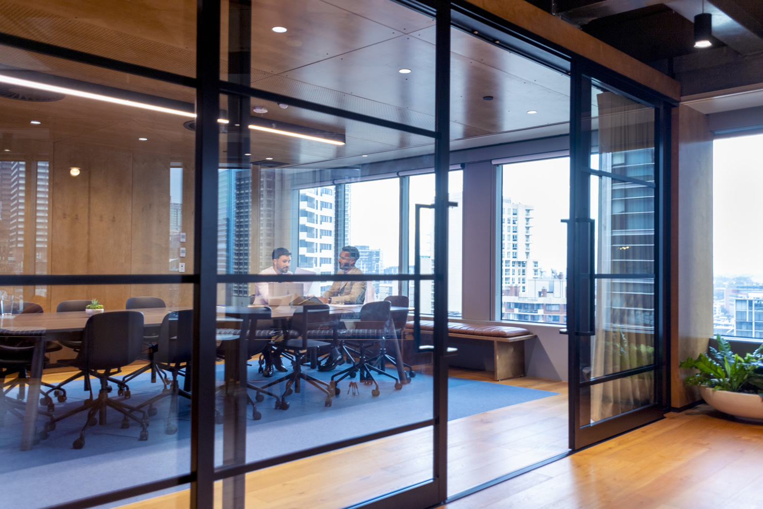 Business people working in a board room with a laptop
