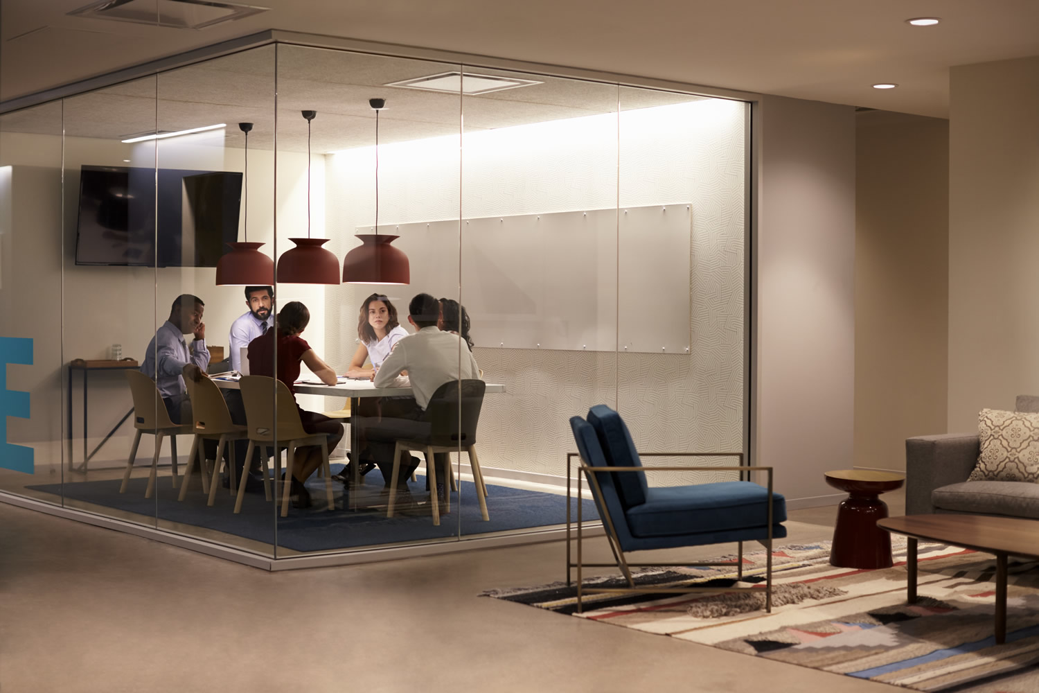Team in a meeting cubicle at a big corporate business
